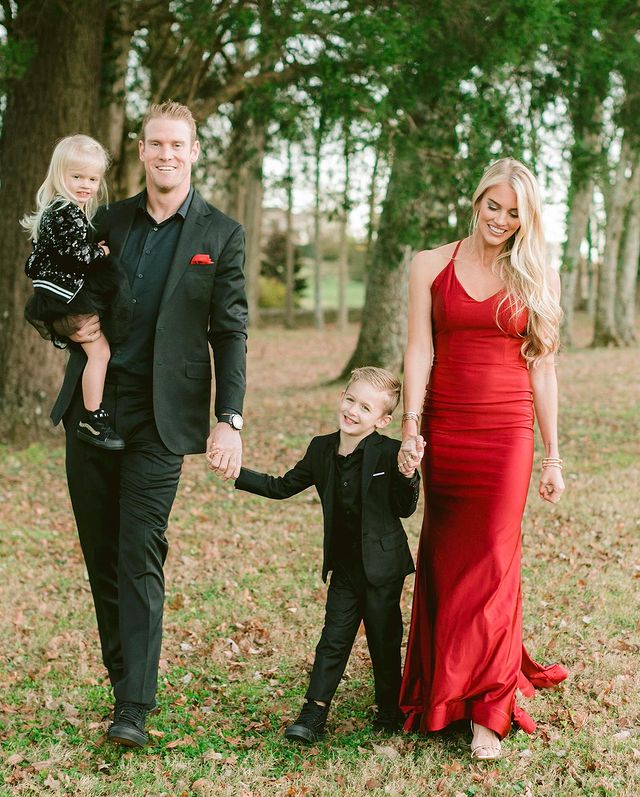 Lauren Tannehill and Ryan Tannehill with their children in black and red party attire.